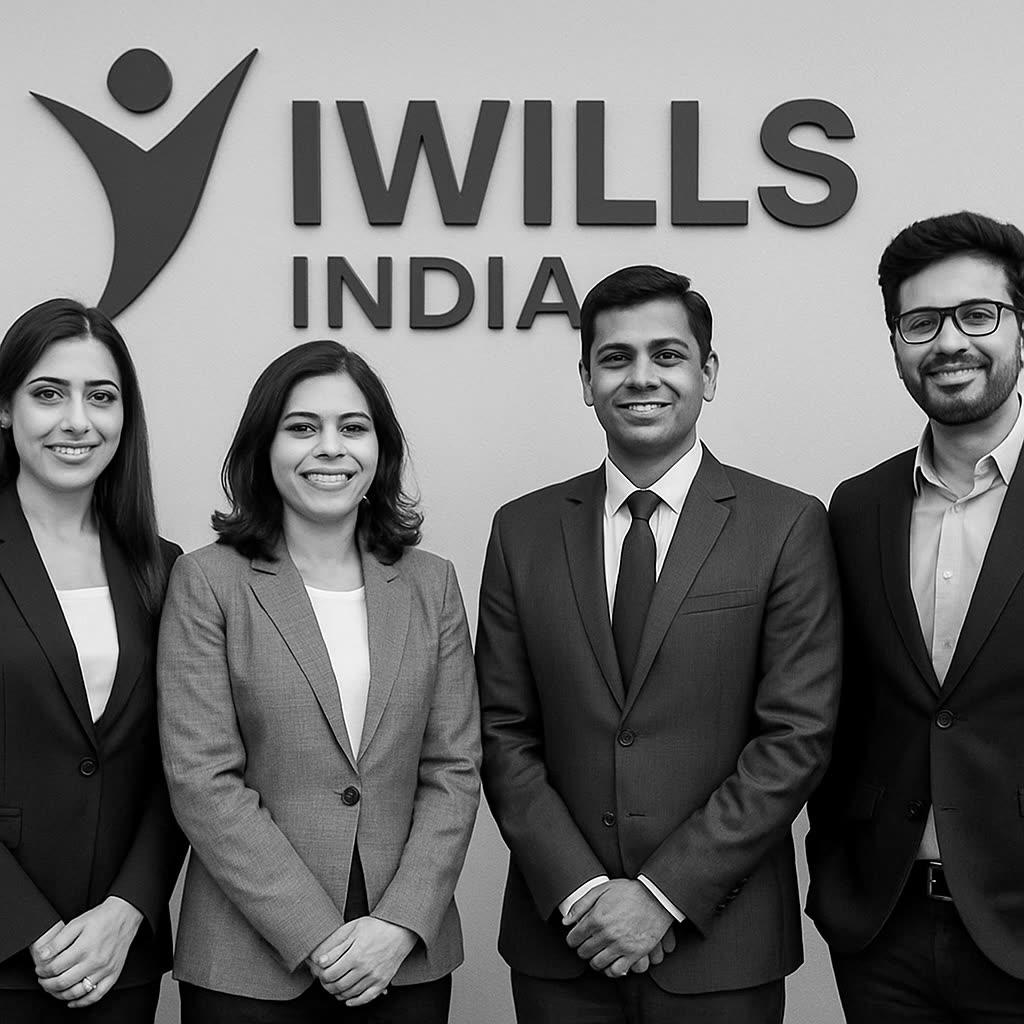 A diverse team of professionals collaborating in a modern office, representing iWills India's mission.